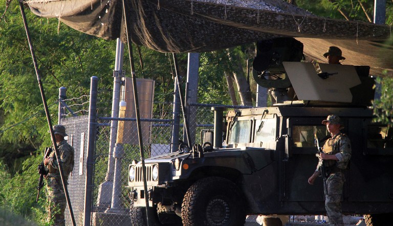 Solders from the Texas Army National Guard keep watch on the banks of the Rio Grande on Wednesday, April 11, 2018, in Roma, Texas.