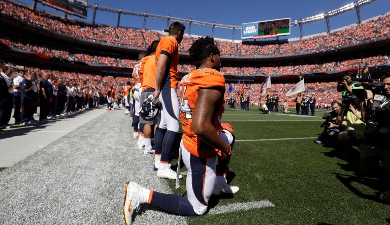 Denver Broncos inside linebacker Brandon Marshall takes a knee during the National Anthem in first half of a NFL football game against the Indianapolis Colts, Sunday, Sept. 18, 2016, in Denver.