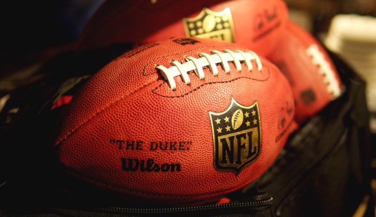 NFL footballs are pictured in a black bag.