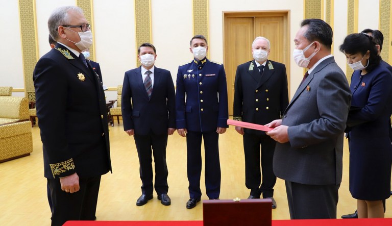 In this handout photo released by Russian Embassy in the DPRK/Russian Foreign Ministry Press Service on Tuesday, May 5, 2020, Russian Ambassador to Democratic Peopleâs Republic of Korea Alexander Matsegora, left, and Democratic Peopleâs Republic of Korea  Foreign Minister Ri Son-gwon, foreground right, both wearing face masks to protect against coronavirus, attend a ceremony of awarding North Korean leader Kim Jong-un with Russiaâs 75th anniversary Victory medal for his major contribution in commemorating Soviet soldiers, who died in 1945 during Koreaâs liberation, at the Mansudae Palace of Congress in Pyongyang, North Korea. Russian President Vladimir Putin has awarded Kim Jong Un a commemorative war medal marking the 75th anniversary of the victory over Nazi Germany. 