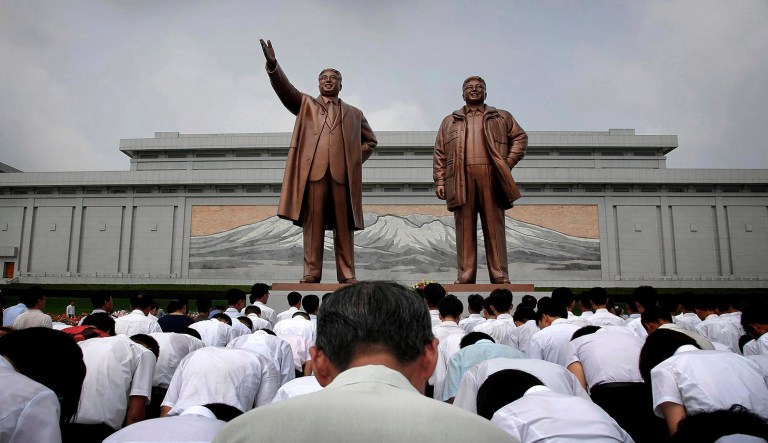 FILE - North Koreans bow in front of bronze statues of the late leaders Kim Il Sung, left, and Kim Jong Il at Munsu Hill in Pyongyang on July 27, 2015. The statues were created by artists from Mansudae Art Studio. Since its opening by Kim Il Sung in 1959, the studio has produced an estimated 38,000 statues and 170,000 other monuments for domestic use.