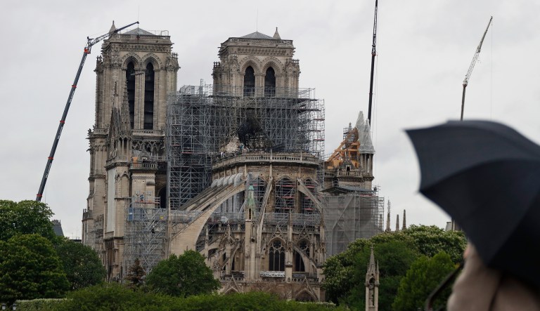 Cranes work at Notre Dame cathedral, in Paris, Thursday, April 25, 2019. French police scientists were starting to examine Notre Dame Cathedral on Thursday for the first time since last week's devastating fire.