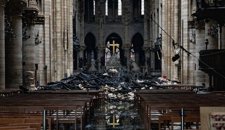 Fire damaged wood and stone sits near the altar inside Notre Dame Cathedral in Paris, France, on Tuesday, April 16, 2019.