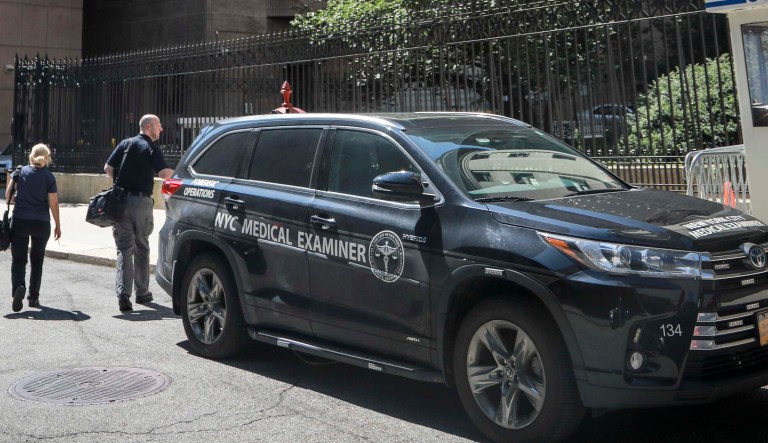 New York City medical examiner personnel leave their vehicle and walk to the Manhattan Correctional Center where financier Jeffrey Epstein died by suicide while awaiting trial on sex-trafficking charges, Saturday Aug. 10, 2019, in New York.