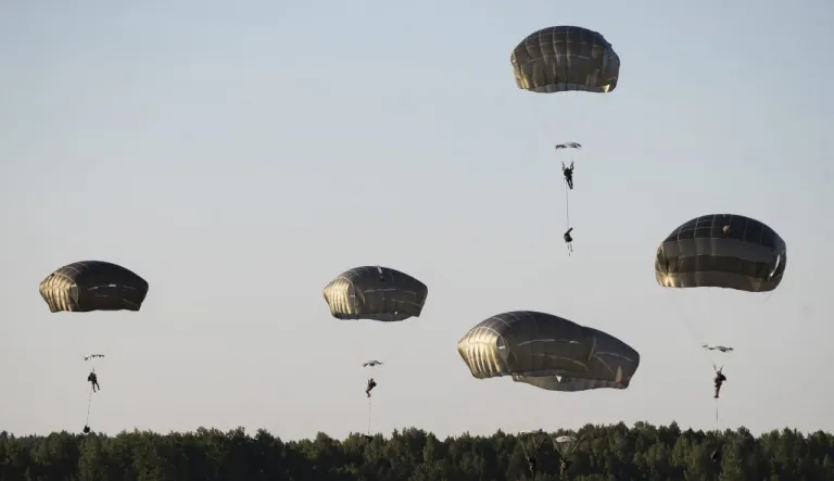 U.S. paratroopers from the 82nd Airborne Division from Fort Bragg in North Carolina, reach the ground after jumping from a US Air Force C-17 aircraft during a 'Saber Strike 2018' military exercises at the Gaiziunai Training Area, some 130 kms (80 miles) west of the capital Vilnius, Lithuania, Saturday, June 9, 2018. A major U.S.-led military exercise with 18,000 soldiers from 19 primarily NATO countries is taking place in the alliance's eastern flank involving Poland and the three Baltic states of Estonia, Latvia, Lithuania.