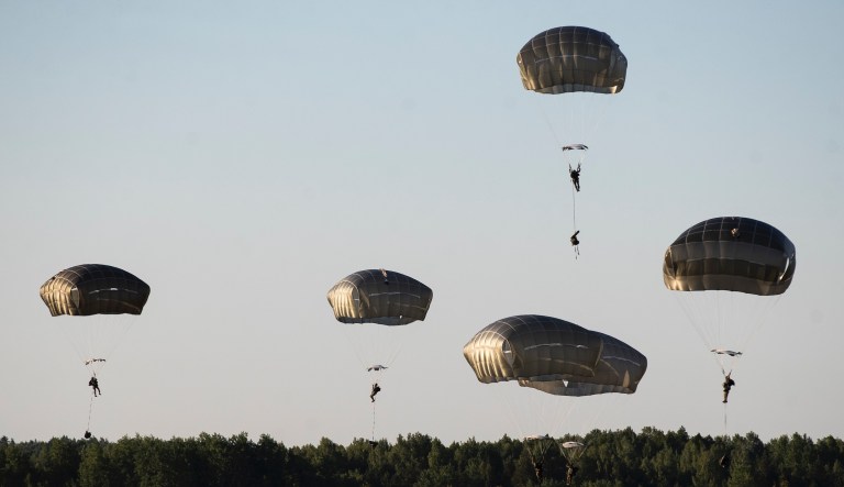 U.S. paratroopers from the 82nd Airborne Division from Fort Bragg in North Carolina, reach the ground after jumping from a US Air Force C-17 aircraft during a 'Saber Strike 2018' military exercises at the Gaiziunai Training Area, some 130 kms (80 miles) west of the capital Vilnius, Lithuania, Saturday, June 9, 2018. A major U.S.-led military exercise with 18,000 soldiers from 19 primarily NATO countries is taking place in the alliance's eastern flank involving Poland and the three Baltic states of Estonia, Latvia, Lithuania.