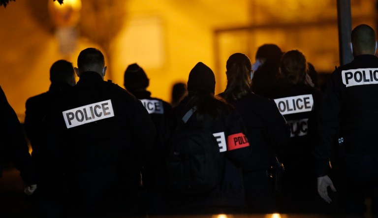 French police officers gather outside a high school after a history teacher who opened a discussion with students on caricatures of Islam's Prophet Muhammad was beheaded, Friday, Oct. 16, 2020 in Conflans-Saint-Honorine, north of Paris. Police have shot the suspected killer dead. 
