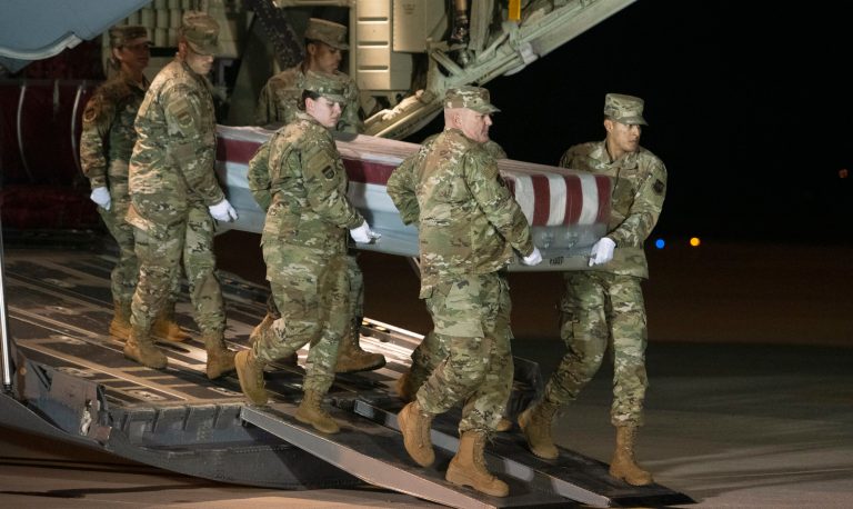 An Air Force carry team moves a transfer case containing the remains of Navy Ensign Joshua Watson on Sunday, Dec. 8, 2019, at Dover Air Force Base, Del. A Saudi gunman killed three people including 23-year-old Watson, a recent graduate of the U.S. Naval Academy from Enterprise, Ala., in a shooting at Naval Air Station Pensacola in Florida.