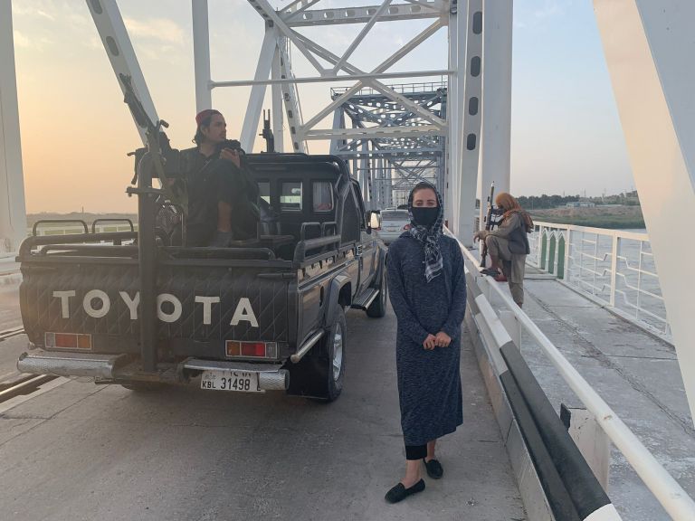 Reporter Hollie McKay being escorted by Taliban fighters to the Uzbek border