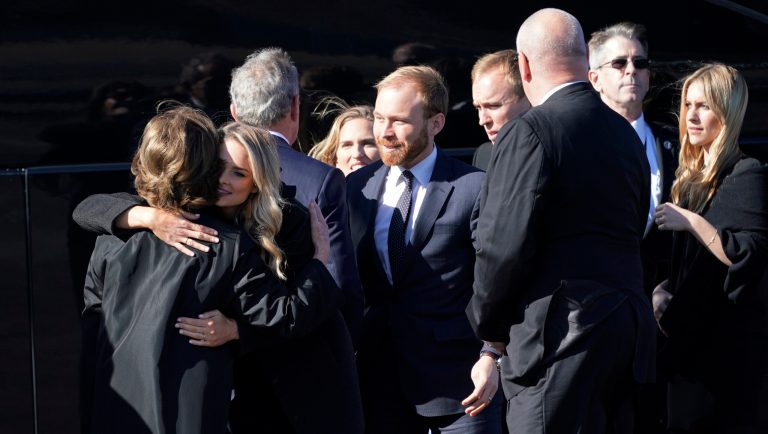 Family members gather before the flag-draped casket of former President George H.W. Bush is loaded onto Special Air Mission 41, the plane that will head to Washington for funeral services, Monday, Dec. 3, 2018, in Houston. Grandson Pierce Bush is at center. 