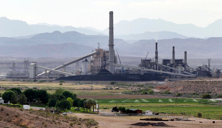 FILE - This May 14, 2012 file photo shows the Reid Gardner Generating Station near a farm on the Moapa Indian Reservation in Moapa, Nev. Environmental advocates and members of Moapa are hailing the closure of the Reid Gardner Generating Station.