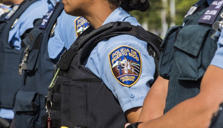 Police officers stand outside the State Elections Commission building during Puerto Rico's status referendum plebiscite in San Juan, Puerto Rico, on Sunday, June 11, 2017. As the economic crisis continues, Puerto Ricans head to the polls in a chance to tell the U.S. Congress whether they want the island territory to join the Union as the 51st state of the United States.