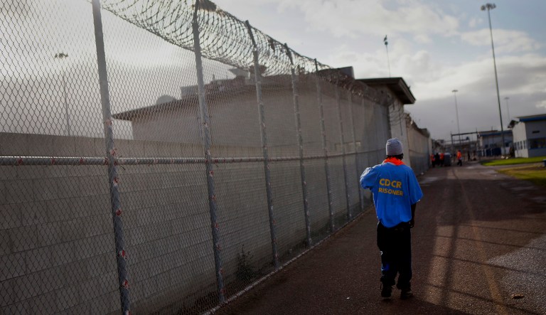 An inmate walks through the yard at the Richard J. Donovan Correctional Facility in San Diego, California, U.S., on Wednesday, March 26, 2014. California is under a federal court order to lower the population of its prisons to 137.5 percent of their designed capacity after the U.S. Supreme Court upheld a ruling that inmate health care was so bad it amounted to cruel and unusual punishment.