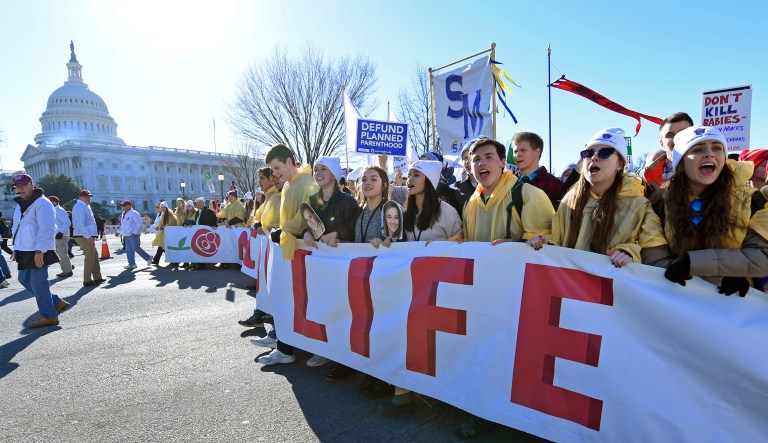 People participate in the March for Life on Capitol Hill in Washington, Friday, Jan. 19, 2018. The march -- which typically draws busloads of Catholic school students, a large contingent of evangelical Christians and poster-toting protesters of many persuasions -- falls each year around the anniversary of the 1973 Roe v. Wade decision that recognized a legal right to abortion and intends to pressure Congress and the White House to limit legal access to the procedure.