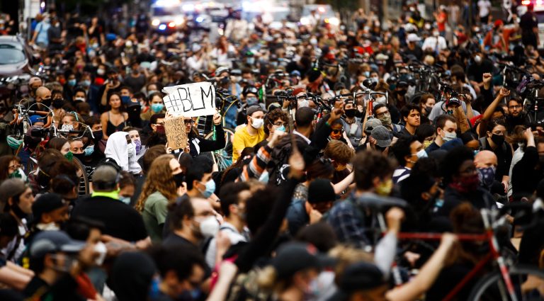 Demonstrators sit in silence for nine minutes, Tuesday, June 2, 2020, in Philadelphia, during a protest over the death of George Floyd, who died May 25 after he was restrained by Minneapolis police.