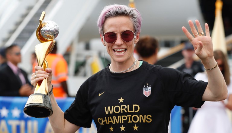 United States women's soccer team member Megan Rapinoe holds the Women's World Cup trophy after arriving at Newark Liberty International Airport, Monday, July 8, 2019, in Newark, N.J. 