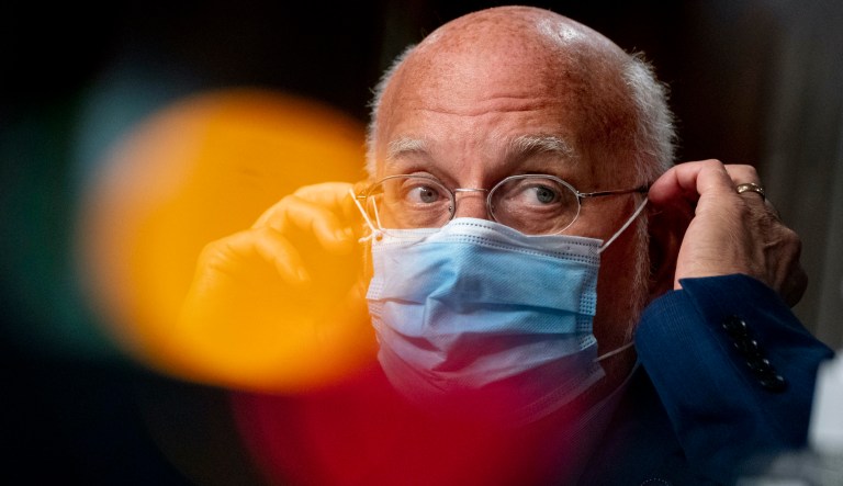 Centers for Disease Control and Prevention Director Dr. Robert Redfield puts his mask back on after speaking at a Senate Appropriations subcommittee hearing on a âReview of Coronavirus Response Effortsâ on Capitol Hill, Wednesday, Sept. 16, 2020, in Washington.