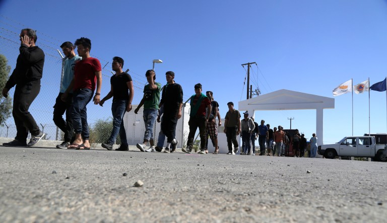FILE - In this Sunday, Sept. 10, 2017 file photo, migrants from Syria walk towards a refugee camp at Kokkinotrimithia, outside of the capital Nicosia, in the eastern Mediterranean island of Cyprus. Cyprus' interior ministry says on Monday, Oct. 23, 2017, larger European Union member states should take on a fairer share of the burden by accepting more migrants for resettlement from other partners on the bloc's fringes that first receive them.