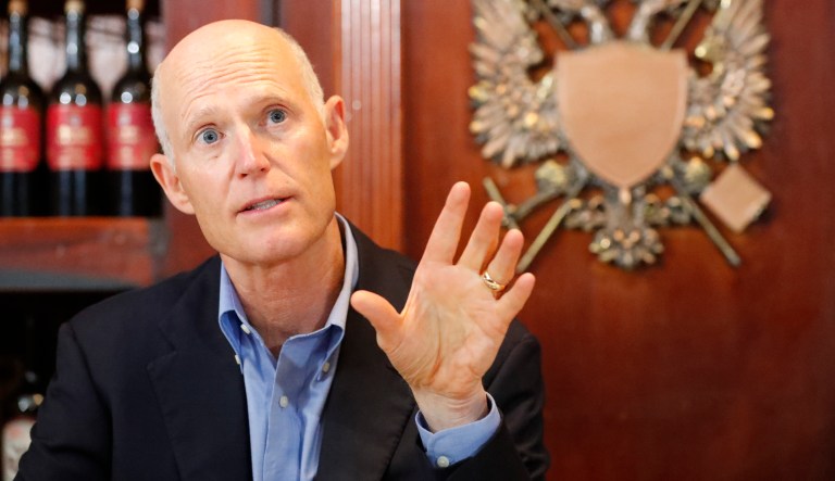Senator Rick Scott, R-Fla., gestures as he speaks to members of the media, Monday, April 15, 2019, at El Porton de la Flaca Colombian restaurant in Doral, Fla. Scott spoke about support for military families and the future of Venezuela after a meeting at U.S. Southern Command.