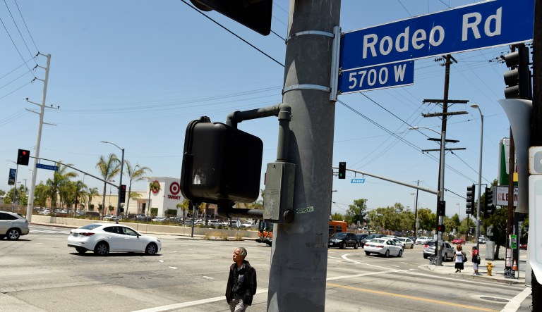 A pedestrian crosses a section of Rodeo Road that will be renamed Obama Boulevard in honor of former President Barack Obama, on Wednesday, June 28, 2017, in Los Angeles. The Los Angeles City Council has voted unanimously to name a street for former President Obama. The motion approved 14-0 Wednesday calls for the city engineer to begin the process of renaming several miles of Rodeo Road as Obama Boulevard.