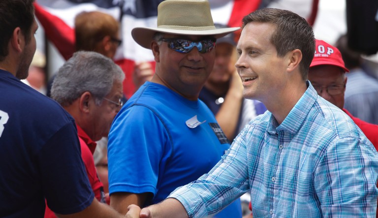 In this Aug. 14, 2014 photo, U.S. Rep. Rodney Davis shakes hands with people attending the Republican Day rally at the Illinois State Fair in Springfield. Davis faces Democrat Ann Callis, the former chief circuit judge in Madison County, in his re-election bid in the November election. 