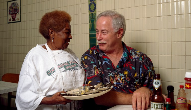 Ronnie Virgets is served the house specialty, ice-cold oysters on the half shell, by Alma Griffin at Casamento's Seafood Restaurant in Uptown New Orleans.