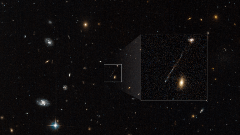 This Hubble Space Telescope archival photo captures a curious linear feature that is so unusual it was first dismissed as an imaging artifact from Hubble's cameras. But follow-up spectroscopic observations reveal it is a 200,000-light-year-long chain of young blue stars. A supermassive black hole lies at the tip of the bridge at lower left.