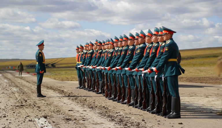 FILE - In this Thursday, Sept. 13, 2018 file photo a Russian honor guard prepares to take a part in a parade prior to a military exercises on training ground "Tsugol", about 250 kilometers (156 miles ) south-east of the city of Chita during Vostok 2018 in Eastern Siberia, Russia. The weeklong Vostok (East) 2018 maneuvers launched Tuesday span vast expanses of Siberia and the Far East, the Arctic and the Pacific Oceans. They involve nearly 300,000 Russian troops along with 1,000 Russian aircraft and 36,000 tanks and other combat vehicles.