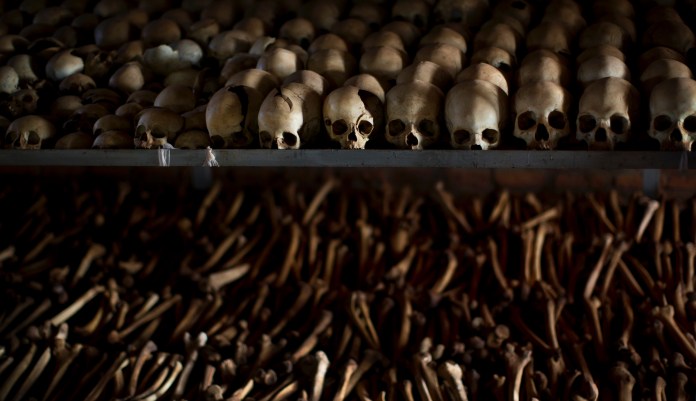 FILE - In this Friday, April 4, 2014 file photo, the skulls and bones of some of those who were slaughtered as they sought refuge inside the church are laid out as a memorial to the thousands who were killed in and around the Catholic church during the 1994 genocide in Ntarama, Rwanda. Felicien Kabuga, one of the most wanted fugitives in Rwanda's 1994 genocide who had a $5 million bounty on his head, has been arrested in Paris, authorities said Saturday, May 16, 2020.