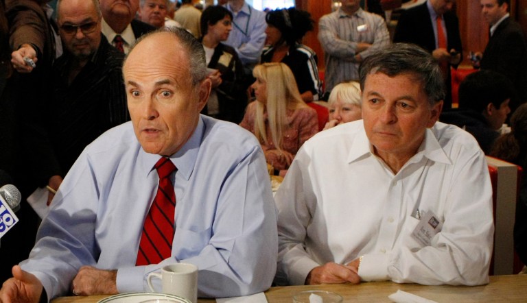 Republican presidential hopeful, former New York City Mayor Rudy Giuliani, eats at Wolfie Cohen's Rascal House Restaurant during a campaign stop in Sunny Isles Beach, Fla., Tuesday, Jan. 29, 2008. Left is Bill McCollum, Florida Attorney General, and right is Jon Sale, senior counselor to the Giuliani campaign.