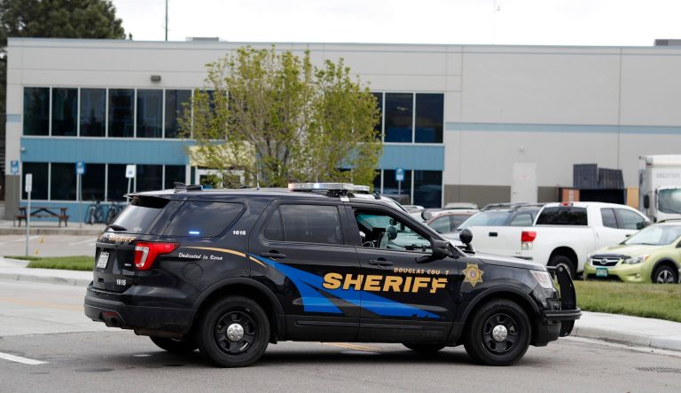 Douglas County, Colo., Sheriffs Department vehicles block the road to the STEM School Highlands Ranch, Tuesday, May 7, 2019, in Highlands Ranch, Colo.