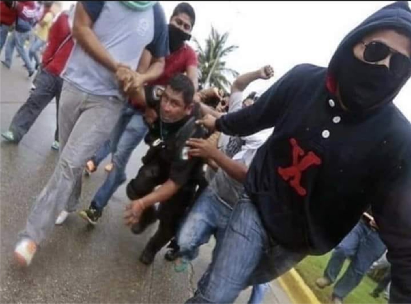 Fact Check: Does This Image Show a “Mexican Official being Dragged by the Caravan”?