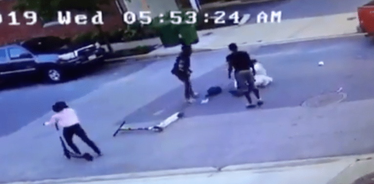 Video shows police employee viciously beaten in Baltimore street