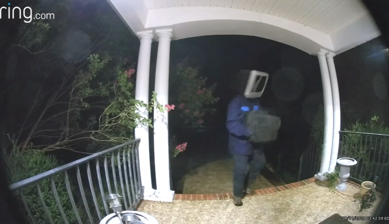 Mysterious man wearing TV on his head leaves old TVs on porches