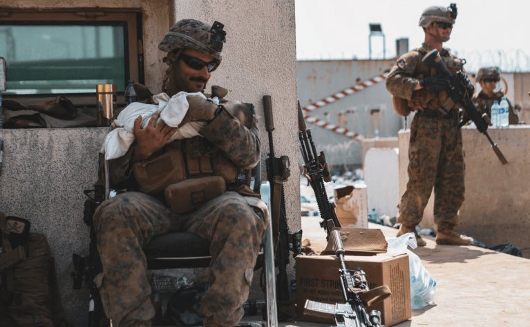 US Marine plucks baby to safety over wall at Kabul airport
