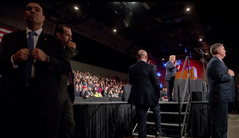 Secret Service agents stand guard as President-elect Donald Trump, second from right, speaks at a rally at Hy-Vee Hall, Thursday, Dec. 8, 2016, in Des Moines, Iowa.