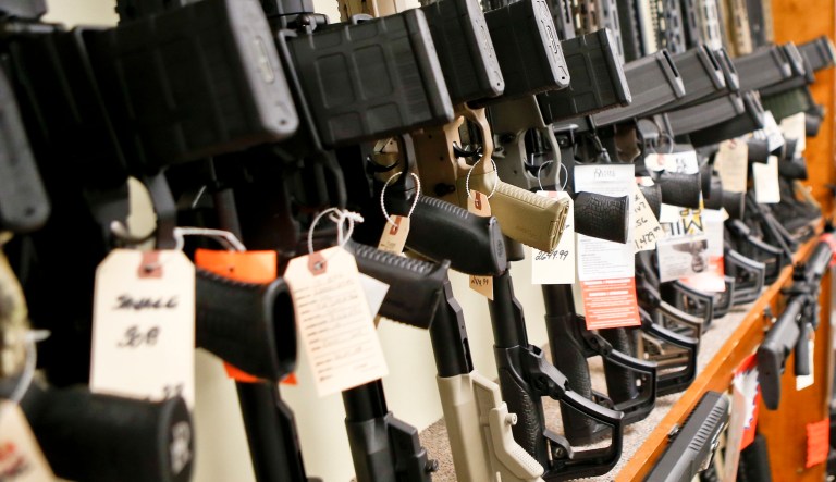 In this March 1, 2018, photo a rack displaying various models of semi-automatic sporting rifles is shown at Duke's Sport Shop in New Castle, Pa.