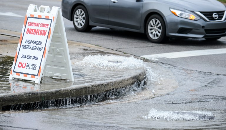 Untreated sewage overflows from two manholes, one on the sidewalk of Central Parkway, left, and the other on 2nd Street Southwest in Decatur, Ala. on Tuesday, February 11, 2020.