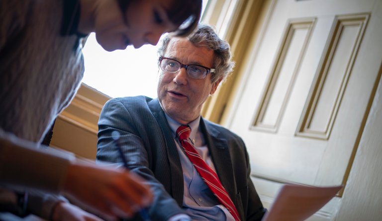 Sen. Sherrod Brown, D-Ohio, right, confers with his communications staffer Katie Mulhall Quintela, left, during a break in President Donald Trump's impeachment trial at the Capitol in Washington, Wednesday, Jan. 29, 2020. (AP Photo/J. Scott Applewhite)