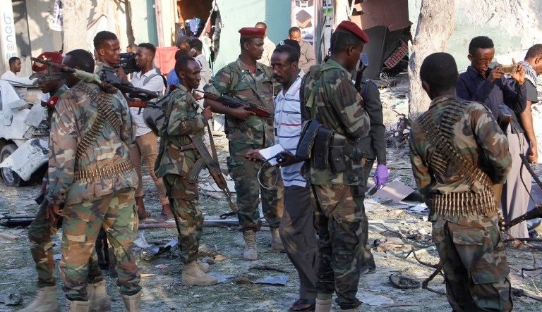 Heavily armed somalis soldiers seal the area after a car bomb exploded in Mogadishu, Somalia Thursday, March 22, 2018.