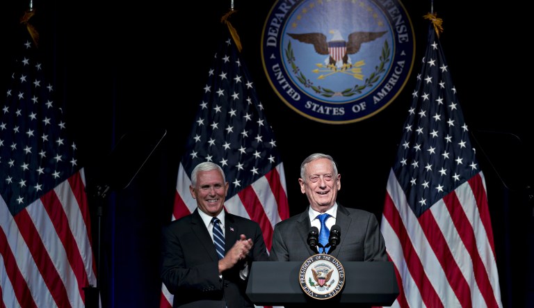 Jim Mattis, U.S. secretary of defense, smiles while introducing U.S. Vice President Mike Pence, left, during an event at the Pentagon in Washington, D.C., U.S., on Thursday, Aug. 9, 2018. President Donald Trump's administration will call on Congress to allocate $8 billion over the next five years to establish the U.S. Space Force as the sixth branch of the military, Pence said today.