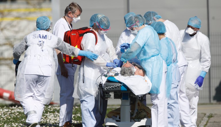 A victim of the Covid-19 virus is evacuated from the Mulhouse civil hospital, eastern France, Monday March 23, 2020. The Grand Est region is now the epicenter of the outbreak in France, which has buried the third most virus victims in Europe, after Italy and Spain. For most people, the new coronavirus causes only mild or moderate symptoms. For some it can cause more severe illness.