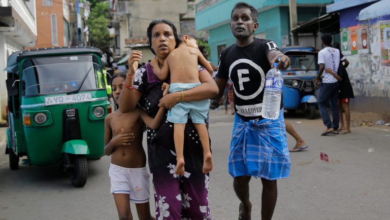 Sri Lankans living near St. Anthony's shrine run for safety after police found explosive devices in parked vehicle, which later exploded in Colombo, Sri Lanka, Monday, April 22, 2019. Easter Sunday bombings that ripped through churches and luxury hotels killed more than 200 people.