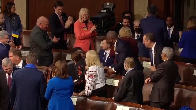 Footage of members standing before State of the Union 