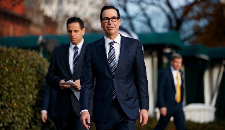 Treasury Secretary Steve Mnuchin walks over to talk with reporters about trade negotiations with China, at the White House, Monday, Dec. 3, 2018, in Washington.
