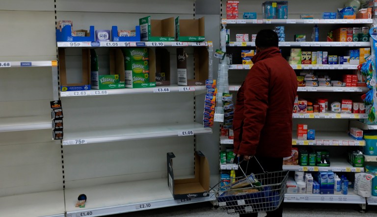 Empty shelves are seen at a Tesco store, in London, Friday, March 13, 2020. For most people, the new coronavirus causes only mild or moderate symptoms, such as fever and cough. For some, especially older adults and people with existing health problems, it can cause more severe illness, including pneumonia.