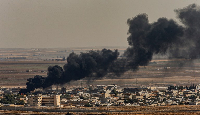In this photo taken from the Turkish side of the border between Turkey and Syria, in Ceylanpinar, Sanliurfa province, southeastern Turkey, smoke billows from fires on targets in Ras al-Ayn, Syria, caused by bombardment by Turkish forces, Sunday, Oct. 13, 2019. Turkey's President Recep Tayyip Erdogan has rejected offers for mediation with Syrian Kurdish fighters as the Turkish military continues its offensive against them in northern Syria.