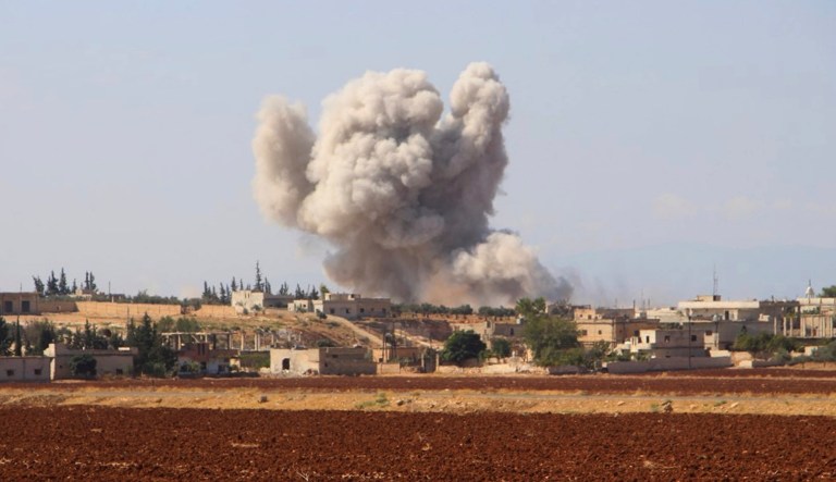 This photo, released on Sept. 10, 2018, by the Syrian Civil Defense group known as the White Helmets, shows smoke rising from a Syrian government airstrike in Hobeit village, near Idlib, Syria.