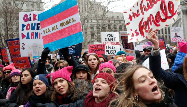 Participants at the Women's March NYC, a rally at Foley Square in Lower Manhattan react as loud music is played between speakers, Saturday, Jan. 19, 2019, in New York. Thousands of people flocked to competing demonstrations, this one in lower Manhattan and another around Central Park and that marched down Sixth Avenue. 