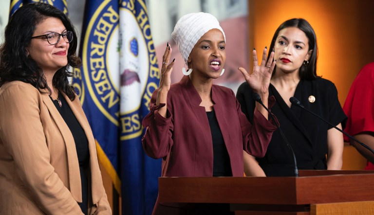 Rep. Ilhan Omar, D-Minn., flanked by Rep. Rashida Tlaib, D-Mich., left, and Rep. Alexandria Ocasio-Cortez, D-N.Y., during a news conference at the Capitol in Washington, Monday, July 15, 2019. 